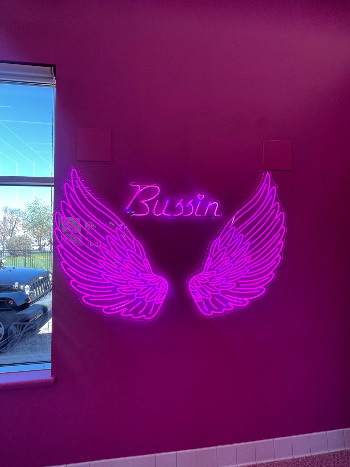 Bussin angel wings neon wall installation — custom neon signs Calgary