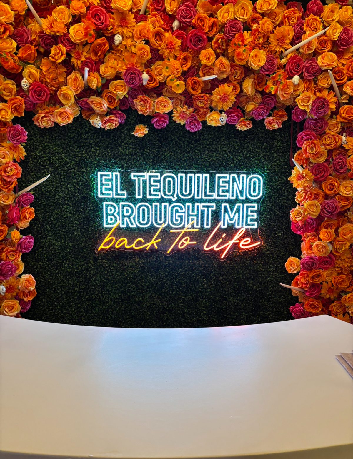 El Tequileño LED neon sign on moss wall — custom neon signs Calgary