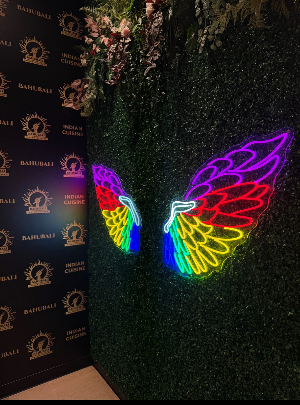 Bahubali Indian Cuisine rainbow wings neon installation — Calgary neon signs