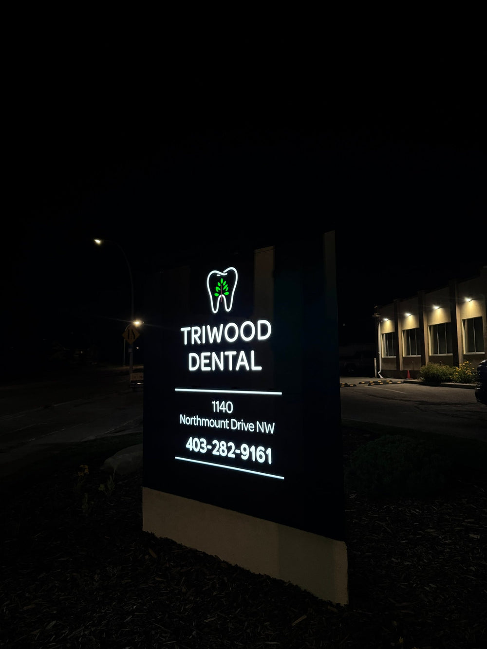 Triwood Dental monument sign front view at night — NEON YYC Calgary