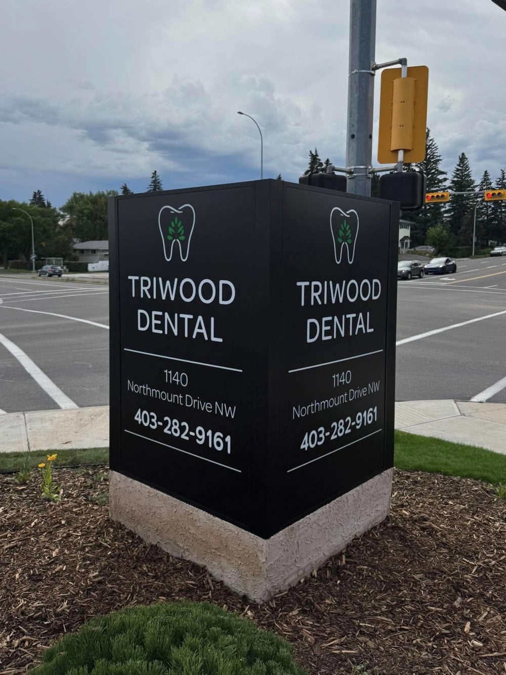 Triwood Dental illuminated monument pylon sign during the day — NEON YYC Calgary